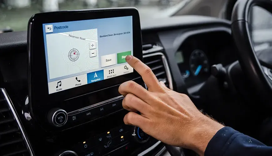 home-collections Close up of a hand touching a touch screen in a car with a map